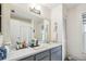 Bathroom featuring a vanity with one sink, large mirror and neutral wall color at 8728 Mcadam Pl, Tampa, FL 33634