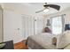 Bedroom featuring hardwood floors, a ceiling fan, and dual closets at 8728 Mcadam Pl, Tampa, FL 33634