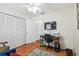 Bedroom featuring a wooden desk, rolling chair, closet, and television at 8728 Mcadam Pl, Tampa, FL 33634