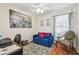 Bedroom featuring a comfortable blue futon, accent pillows, and a large city print at 8728 Mcadam Pl, Tampa, FL 33634