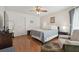 Bright bedroom with hardwood floors, ceiling fan, and neutral decor at 8728 Mcadam Pl, Tampa, FL 33634