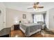 Comfortable bedroom featuring hardwood floors and a ceiling fan at 8728 Mcadam Pl, Tampa, FL 33634