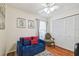 Bedroom featuring a comfortable blue futon, accent pillows, and a closet with white doors at 8728 Mcadam Pl, Tampa, FL 33634