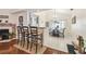 Kitchen bar with chairs and access to open dining area at 8728 Mcadam Pl, Tampa, FL 33634