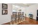 Kitchen bar with three chairs on woven rug and access to dining area at 8728 Mcadam Pl, Tampa, FL 33634