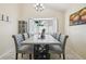 Traditional dining room with bay window, modern chandelier and seating for eight at 8728 Mcadam Pl, Tampa, FL 33634