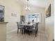 Elegant dining room with bay window, chandelier, and seating for six at 8728 Mcadam Pl, Tampa, FL 33634