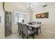 Charming dining room with window view and modern chandelier at 8728 Mcadam Pl, Tampa, FL 33634