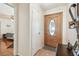 Inviting entryway with wood door and tile flooring leads to bedroom at 8728 Mcadam Pl, Tampa, FL 33634
