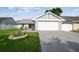 Charming single-story home featuring a well-maintained lawn and a two-car garage at 8728 Mcadam Pl, Tampa, FL 33634