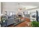Cozy living room featuring a fireplace, wood floors, and open access to the dining area at 8728 Mcadam Pl, Tampa, FL 33634