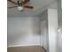 Bright living room featuring neutral walls, tile flooring and a ceiling fan at 8728 Mcadam Pl, Tampa, FL 33634