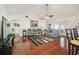 Inviting living room with vaulted ceiling, wood floors, and access to outdoor space at 8728 Mcadam Pl, Tampa, FL 33634
