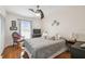 Comfortable main bedroom featuring hardwood floors and a ceiling fan at 8728 Mcadam Pl, Tampa, FL 33634