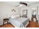 Comfortable main bedroom featuring hardwood floors and a ceiling fan at 8728 Mcadam Pl, Tampa, FL 33634