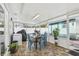 Enclosed patio features tiled flooring, dining table set, grill, and storage at 8728 Mcadam Pl, Tampa, FL 33634