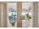 View through open doors to a covered patio with seating and an open backyard at 8728 Mcadam Pl, Tampa, FL 33634