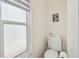 Compact half bathroom featuring toilet with frosted glass window at 8728 Mcadam Pl, Tampa, FL 33634