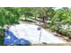 Outdoor basketball court surrounded by mature trees and lush greenery at 915 Rolling Hills Dr, Palm Harbor, FL 34683