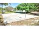Outdoor basketball court for residents with mature trees and plenty of room to play at 915 Rolling Hills Dr, Palm Harbor, FL 34683