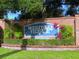 Westlake Village entrance sign with lush landscaping, community information, and brick surround at 915 Rolling Hills Dr, Palm Harbor, FL 34683