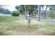 Community disc golf course for residents with lush green grass, mature trees, and a paved walking path at 915 Rolling Hills Dr, Palm Harbor, FL 34683