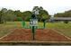 Community lower body exercise station with instructions and wood chip ground covering at 915 Rolling Hills Dr, Palm Harbor, FL 34683
