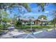 Community building with a walkway, well-maintained landscaping, and sign welcoming you to the park at 915 Rolling Hills Dr, Palm Harbor, FL 34683