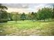 Scenic grounds with a grassy lawn, walking paths, trees and a pond for enjoying the outdoors and nature at 915 Rolling Hills Dr, Palm Harbor, FL 34683
