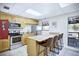 Modern kitchen with stainless steel appliances, granite countertops, and a breakfast bar at 915 Rolling Hills Dr, Palm Harbor, FL 34683