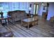 Cozy living room featuring hard wood floors, a comfortable sofa, and shuttered windows at 915 Rolling Hills Dr, Palm Harbor, FL 34683
