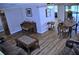 Open-concept living and dining space with hardwood flooring, antique furniture, and neutral paint at 915 Rolling Hills Dr, Palm Harbor, FL 34683