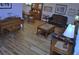 Elegant living room with wood floors, a decorative piano, dining table and comfortable seating at 915 Rolling Hills Dr, Palm Harbor, FL 34683