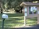 Community Mailbox and Information Kiosk Located in a serene grassy area with mature trees at 915 Rolling Hills Dr, Palm Harbor, FL 34683