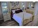 Elegant main bedroom with wood flooring, a decorative wall, and stylish furniture at 915 Rolling Hills Dr, Palm Harbor, FL 34683