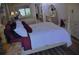 Elegant main bedroom with wood flooring, a decorative wall, and stylish furniture at 915 Rolling Hills Dr, Palm Harbor, FL 34683