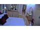 Elegant main bedroom with wood flooring, a decorative wall, and stylish furniture at 915 Rolling Hills Dr, Palm Harbor, FL 34683