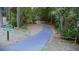 A paved park trail with a welcome sign and split rail fencing at 915 Rolling Hills Dr, Palm Harbor, FL 34683