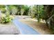 Paved path with greenery and natural foliage for enjoying a walk in the park or a bike ride at 915 Rolling Hills Dr, Palm Harbor, FL 34683