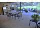 Spacious screened patio with dining table, fire pit and cushioned seating area perfect for entertaining at 915 Rolling Hills Dr, Palm Harbor, FL 34683