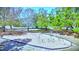 A colorful playground features swings and climbing bars, surrounded by lush trees and greenery at 915 Rolling Hills Dr, Palm Harbor, FL 34683