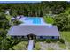 Charming clubhouse with swimming pool and manicured landscaping at 915 Rolling Hills Dr, Palm Harbor, FL 34683