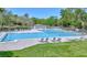The inviting swimming pool is surrounded by lounge chairs and lush greenery, offering a relaxing escape at 915 Rolling Hills Dr, Palm Harbor, FL 34683