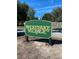 Westlake Village community entrance sign nestled among landscaped greenery with a clear blue sky at 915 Rolling Hills Dr, Palm Harbor, FL 34683