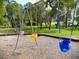 Vibrant, colorful swing sets on mulch base offer children a fun and safe playing area at 915 Rolling Hills Dr, Palm Harbor, FL 34683