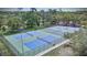 A view from above showcases all of the tennis/pickle ball courts at 915 Rolling Hills Dr, Palm Harbor, FL 34683