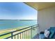 Inviting balcony view showcasing scenic waterfront, lush greenery, and comfortable outdoor seating arrangement at 1 Key Capri # 303E, Treasure Island, FL 33706