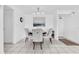 Bright dining room featuring a modern chandelier, stylish furniture, and contemporary decor at 1 Key Capri # 303E, Treasure Island, FL 33706