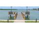 Wooden dock overlooking a waterfront with benches and lights, perfect for fishing or relaxing by the water at 1 Key Capri # 303E, Treasure Island, FL 33706