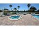 A beautiful hot tub sits near the pool and has a clear view of the bright sky above at 1 Key Capri # 303E, Treasure Island, FL 33706